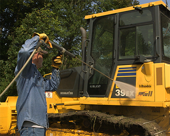 Power washing bulldozer